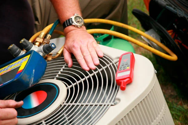 Technician servicing a condenser unit