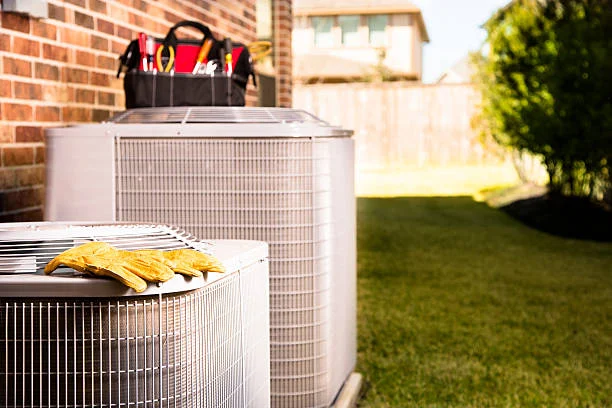 Residential AC condensers with a technician's tool bag