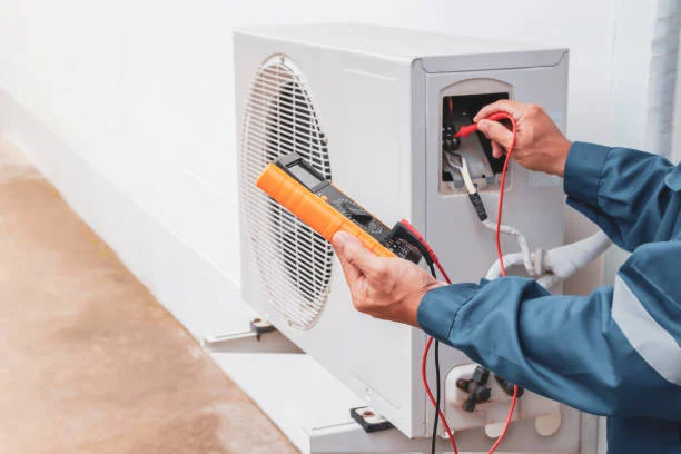 Technician testing an HVAC unit with a multimeter