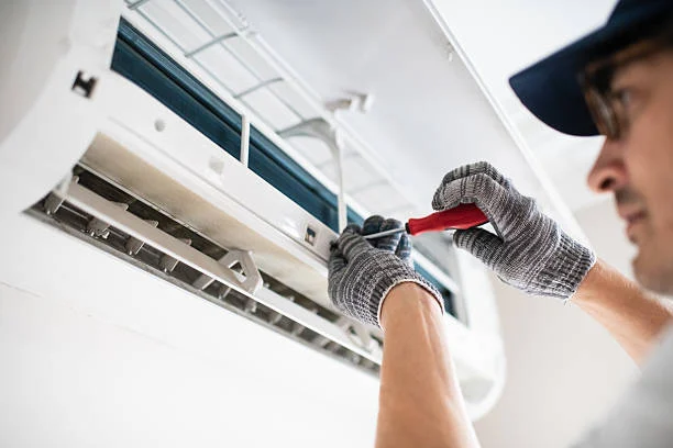 Technician servicing an indoor air handler