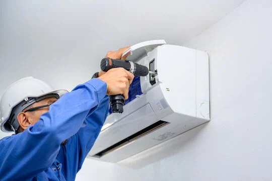 Technician installing a wall-mounted mini split
